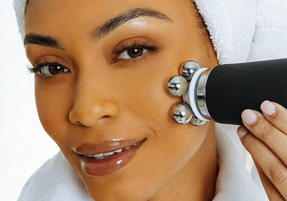 Woman using a facial massager on her face with a white background